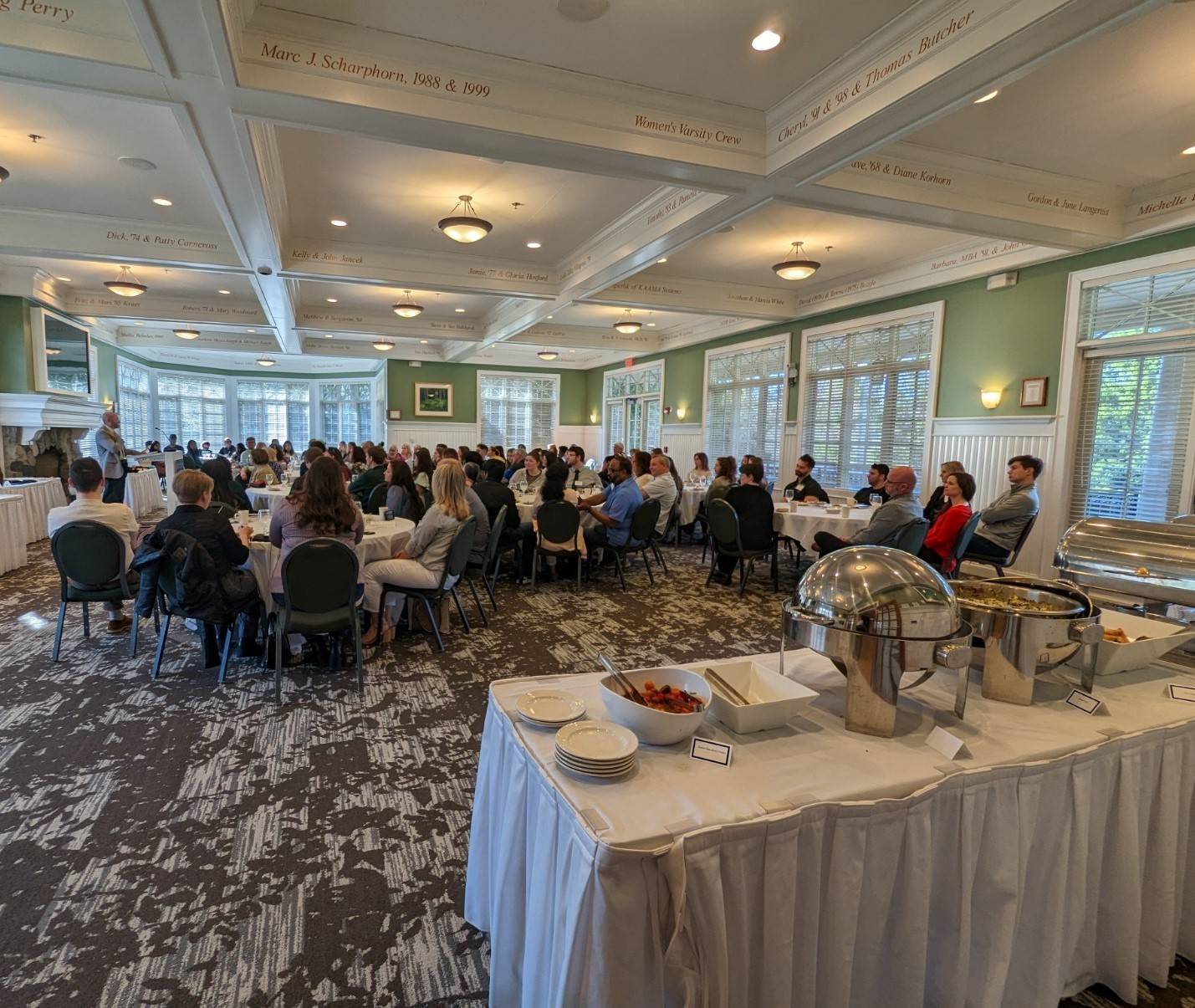 Man standing at podium speaking to room of people